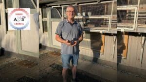 Fancier Dreger holding his winning racing pigeon outside the loft after claiming 1st place in Derby AS Croatia 2026 Race 4 from Nove Zamky.