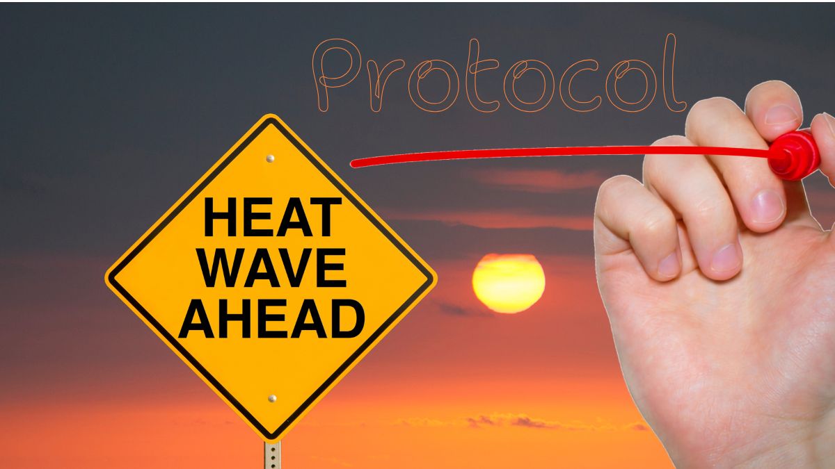 Heat wave ahead warning sign pointing to heat protocol text for pigeon racing summer loft management.