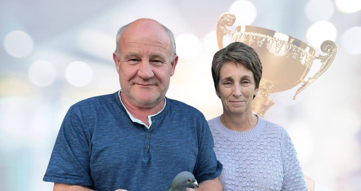 Huub Hermans and his wife Diana holding a champion racing pigeon with a gold trophy overlay on PigeonBoss.com.