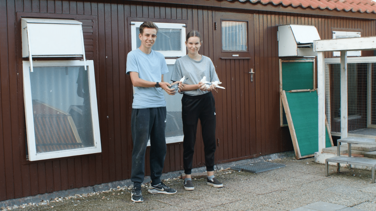 Corjan and Annemiek Tiggelman holding racing pigeons outside their Middelharnis loft, the team behind the Cambrai clean sweep.