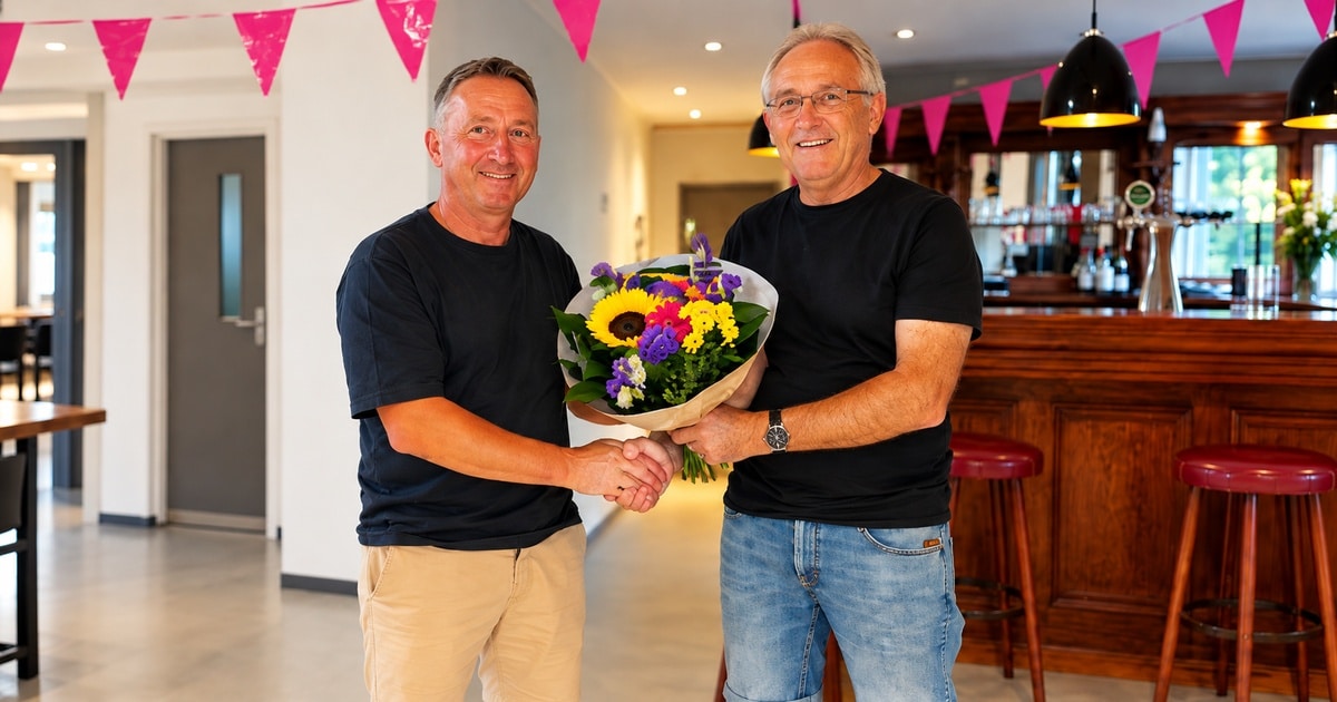 Home 7 Patrick Hermes receives flowers after his National Narbonne victory in a bright clubhouse setting.